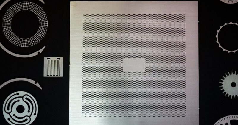 square shaped and silver colored photo etched part