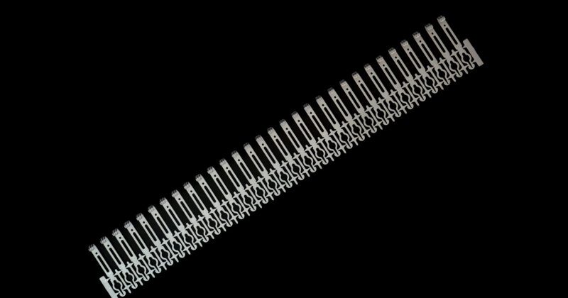 silver colored and small photo etched part for metal hardware