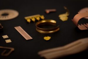 collage of gold colored phosphorous bronze photo etched parts