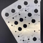 silver laser cut part, several laser cut holes