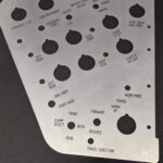 silver laser cut part, several laser cut holes